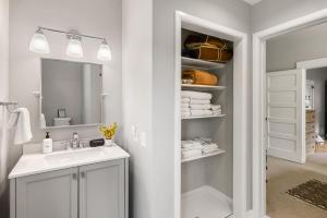 a bathroom with a sink and a mirror and towels at 7th Street Bungalow in Livingston +33 photos