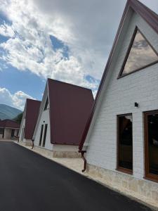 a row of white buildings with red roofs at Viaggio Berane in Berane +2 photos