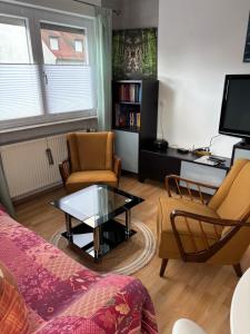 a living room with a couch and a coffee table at Ferienwohnung Aurach in Aurach