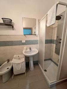 a bathroom with a sink toilet and a shower at Appartamenti la terrazza in Pachino +8 photos
