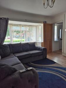 a living room with a couch and a rug at Quiet and professional friendly in Cardiff +1 photo