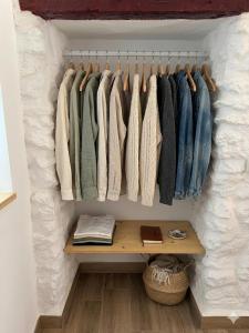 a walk in closet with a row of clothes at Loft A el Ramellet in Alginet