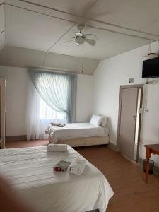 a hotel room with two beds and a ceiling fan at Formule 11 in Frankfort