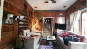 a living room with a brick wall at The Brick Nest in Perumpāvūr