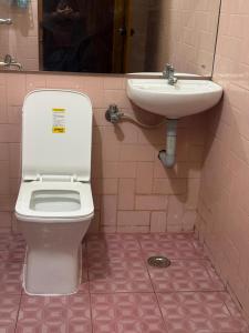 a bathroom with a toilet and a sink at The Brick Nest in Perumpāvūr +50 photos