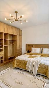 a bedroom with a bed and a ceiling fan at 2Bedroom Apartment and Living Room at Shiekh Zayed in Sheikh Zayed