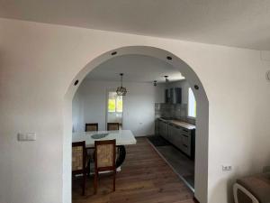 a kitchen and dining room with a table and chairs at Apartman Kastel in Travnik +10 photos