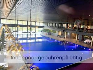 a large swimming pool in the middle of a building at Am Südwesthorizont App 185 in Timmendorfer Strand