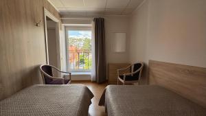 a hospital room with two beds and a window at Parko Studija in Birštonas
