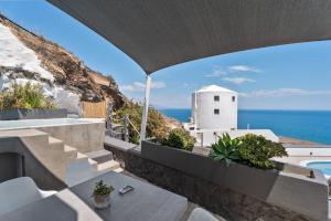 a villa with a view of the ocean at Topos Exclusive Santorini in Imerovigli