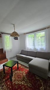 a living room with a couch and a table at Domek na jeziorem in Ostróda