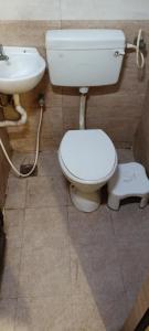 a bathroom with a toilet and a sink at ZOLO Stays in Chennai