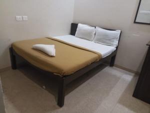 a bed with two pillows on it in a room at ZOLO Stays in Chennai