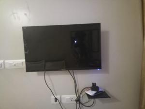 a flat screen tv hanging on a wall at ZOLO Stays in Chennai