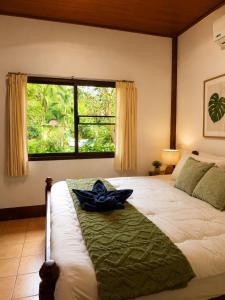 a bedroom with a large bed with a large window at Hidden Home Samui in Koh Samui +13 photos