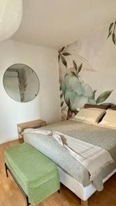 a bedroom with a bed and a mirror on the wall at Nella Corte - La Casetta in Corte Franca