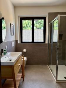 a bathroom with a sink and a shower at Nella Corte - La Casetta in Corte Franca +12 photos