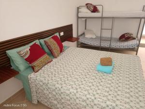 a small bedroom with a bed with pillows at Fort Apartments in Vila do Porto