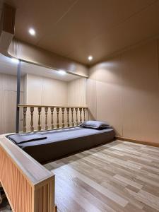 a bedroom with a large bed in a room at Red-N House in Tashkent