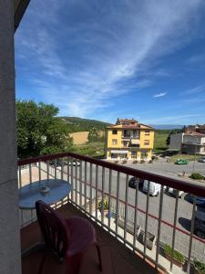 a balcony with a table and chairs and a building at Valdambra B&B in Ambra