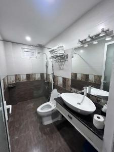 a bathroom with a sink and a toilet and a mirror at Michael Hotel in Nha Trang +18 photos