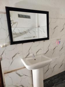 a bathroom with a white sink and a mirror at Mount crest homestay in Kandy +16 photos