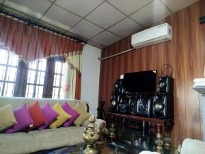 a living room with a couch and a tv at Mount crest homestay in Kandy