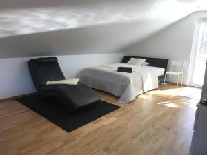 a bedroom with a bed and a chair at Studio i Nykvarn in Nykvarn