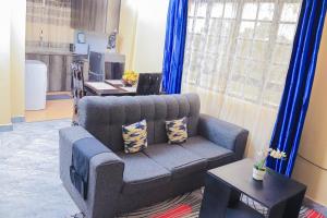 a living room with a couch and a table at Countryside Apartment 1 in Kiambu
