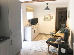 a living room with a couch and a table at Gite Julie Anne in Ussat