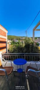 a blue table and chairs on a balcony at Green Boat House in Skala