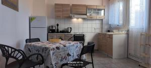 a kitchen with a table and chairs and a kitchen with a refrigerator at Green Boat House in Skala +16 photos