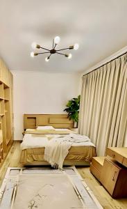 a bedroom with a bed and a ceiling fan at Elegant Apartment at Sheikh Zayed Compound in Sheikh Zayed