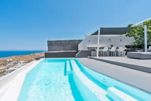 a swimming pool with a view of the ocean at Topos Exclusive Santorini in Imerovigli