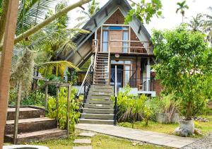 a brick house with stairs leading up to it at Steps Garden Resort in Negombo