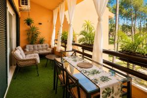 a porch with tables and chairs and a couch at Lo Exclusive Lisboa - Apartament with terrace and golf view in Charneca