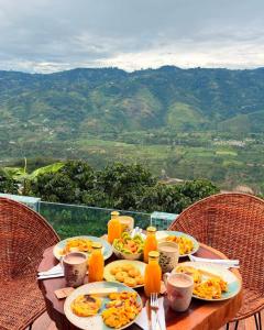 a table with plates of food and drinks on it at Montecielo in Pitalito