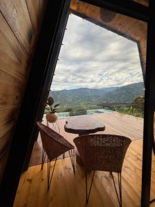 a room with a table and chairs and a large window at Montecielo in Pitalito