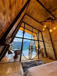 a bedroom with a large window with a surfboard in it at Montecielo in Pitalito