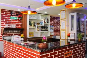 a bar in a restaurant with a brick wall at Hotel Kusum Palace in Kathmandu +19 photos