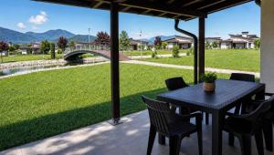 a black table and chairs on a patio with a bridge at Sarajevo Resort Gestoria in Hadžići +2 photos