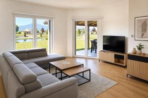 a living room with a couch and a television at Sarajevo Resort Gestoria in Hadžići
