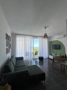 a living room with a couch and a table at Andrra Apartment - Talea Coast in Lezhë