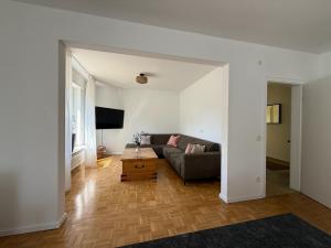 a living room with a couch and a table at Karolinger Stay in Emmerich