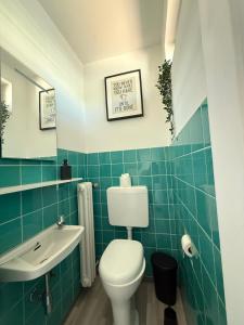 a bathroom with a toilet and a sink at Karolinger Stay in Emmerich +17 photos