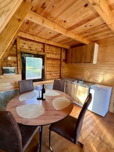 a dining room with a table and chairs in a cabin at Retreat Komovi in Andrijevica +61 photos