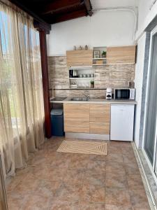 a kitchen with a sink and a microwave at Kallisti House in Nea Vrasna +29 photos