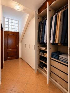 a walk in closet with white cabinets and a door at Sa Omu 'e Pinucciu in Lanusei