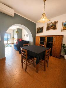 a dining room with a black table and chairs at Sa Omu 'e Pinucciu in Lanusei +16 photos