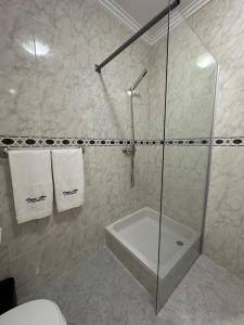 a bathroom with a shower with a tub and a toilet at Praia - Mar in Ovar +10 photos